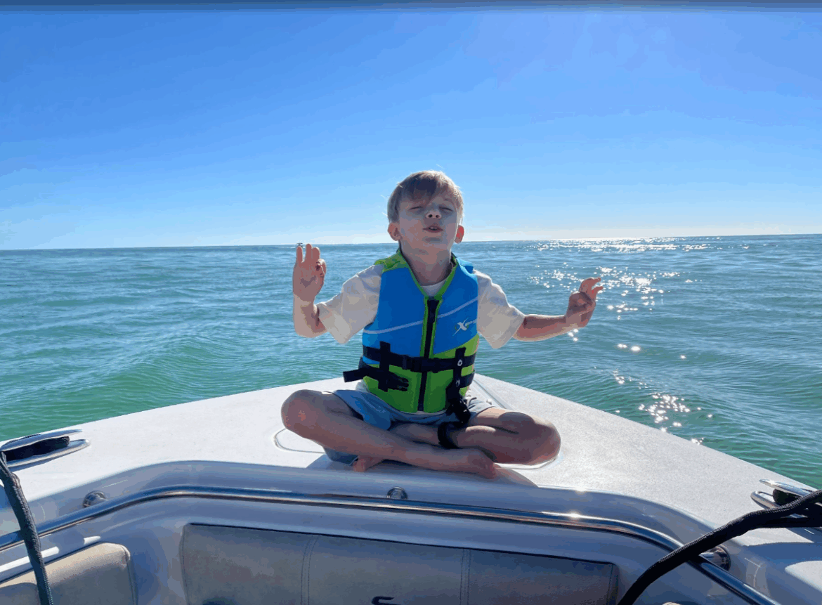 Child meditating on boat